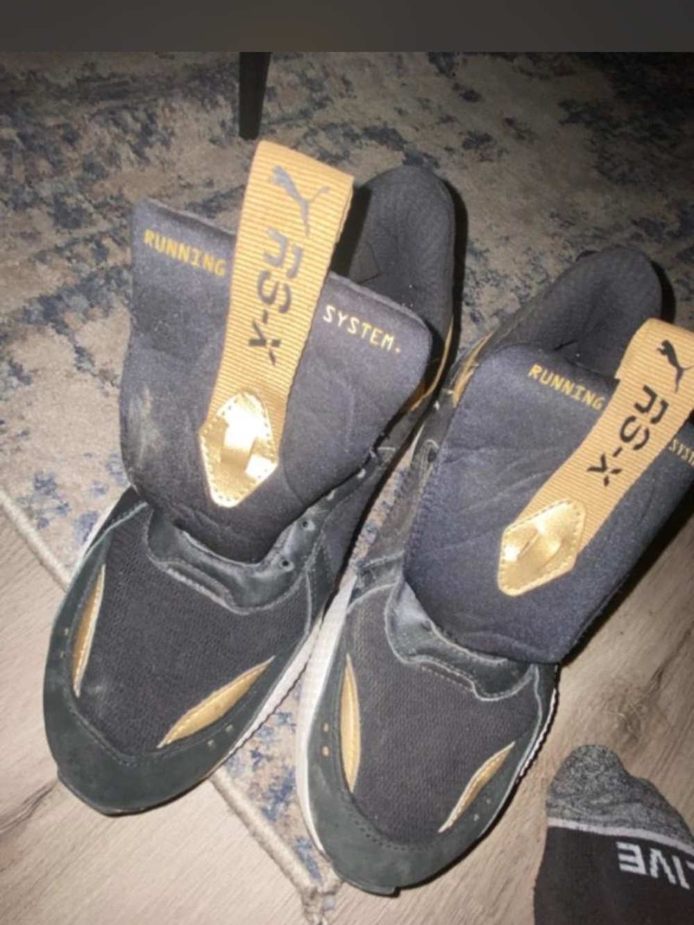 Puma Men’s Black and Gold Slip-On Running Sneakers